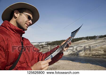 Tourist looking at a map, Yellowstone National Park, USA View Large Photo Image Stock Image - Tourist looking at a map, Yellowstone National Park, USA. Fotosearch