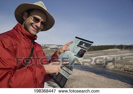 Tourist pointing at a map, Yellowstone National Park, USA View Large Photo Image Stock Photo - Tourist pointing at a map, Yellowstone National Park, USA. Fotosearch