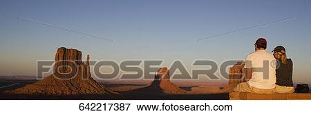 Tourists looking at rock formations in a valley, Monument Valley Tribal Park, Arizona-Utah, USA View Large Photo Image Stock Photo - Tourists looking at rock formations in a valley, Monument Valley Tribal Park, Arizona-Utah, USA. Fotosearch