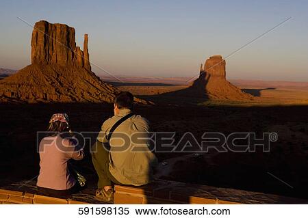 Tourists looking at rock formations in a valley, Monument Valley Tribal Park, Arizona-Utah, USA View Large Photo Image Stock Photography - Tourists looking at rock formations in a valley, Monument Valley Tribal Park, Arizona-Utah, USA. Fotosearch