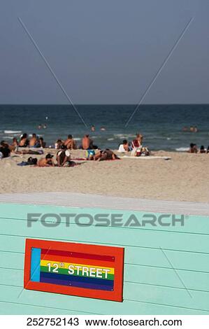 Stock Image - Tourists on the beach, Miami Beach, Florida, USA. Fotosearch