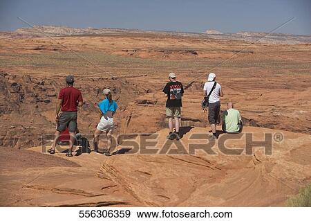 Tourists standing on an arid landscape, Horseshoe Bend, Page, Arizona, USA View Large Photo Image Stock Photo - Tourists standing on an arid landscape, Horseshoe Bend, Page, Arizona, USA. Fotosearch