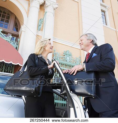 Two business executives looking at each other and smiling, Biltmore Hotel, Coral Gables, Florida, USA View Large Photo Image Picture - Two business executives looking at each other and smiling, Biltmore Hotel, Coral Gables, Florida, USA. Fotosearch
