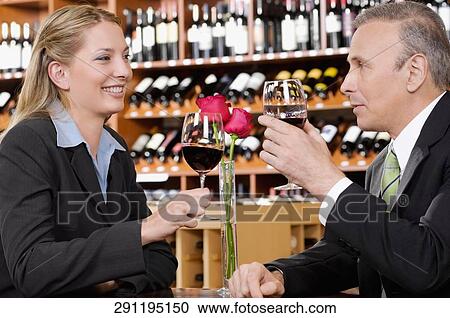Two business executives toasting with wine View Large Photo Image Stock Image - Two business executives toasting with wine. Fotosearch
