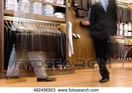 Two businessmen shopping in a clothing store View Large Photo Image Stock Image - Two businessmen shopping in a clothing store. Fotosearch