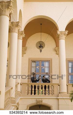 Picture - Two businessmen standing in the balcony, Biltmore Hotel, Coral Gables, Florida, USA. Fotosearch