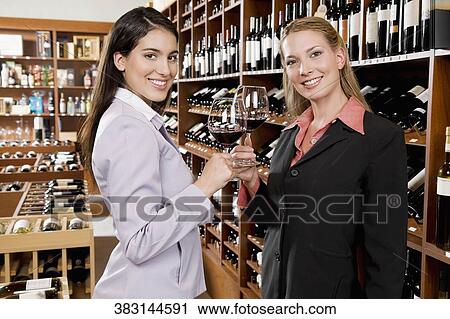 Two businesswomen toasting with wine in a bar View Large Photo Image Stock Image - Two businesswomen toasting with wine in a bar. Fotosearch