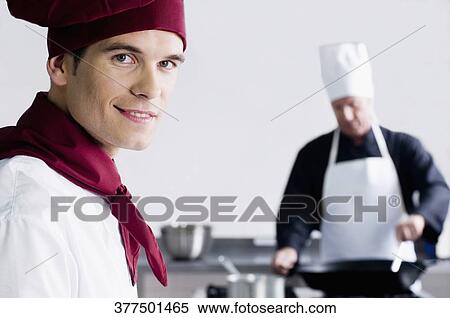 Two chefs cooking food in the kitchen View Large Photo Image Stock Photography - Two chefs cooking food in the kitchen. Fotosearch