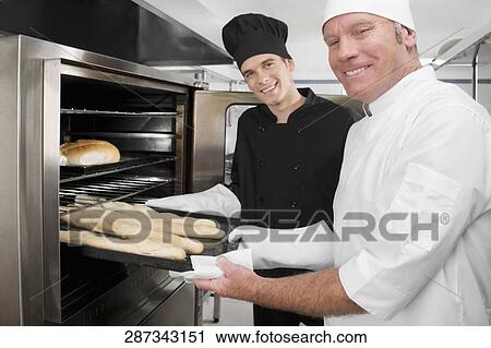 Two chefs preparing food in the kitchen View Large Photo Image Stock Image - Two chefs preparing food in the kitchen. Fotosearch