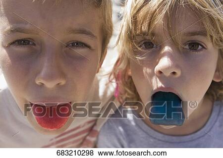 Two children showing their colored tongues View Large Photo Image Stock Photo - Two children showing their colored tongues. Fotosearch