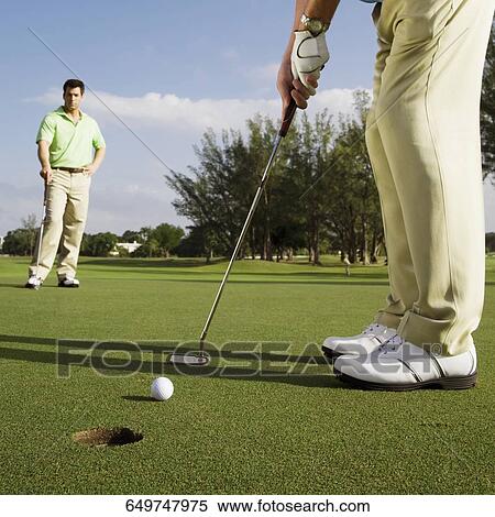 Two golfer playing golf in a golf course, Biltmore Golf Course, Coral Gables, Florida, USA View Large Photo Image Stock Photography - Two golfer playing golf in a golf course, Biltmore Golf Course, Coral Gables, Florida, USA. Fotosearch