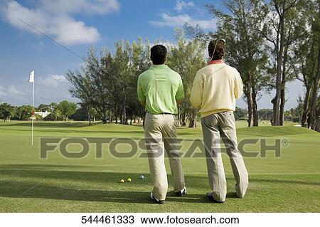 Two golfer standing in a golf course, Biltmore Golf Course, Coral Gables, Florida, USA View Large Photo Image Stock Image - Two golfer standing in a golf course, Biltmore Golf Course, Coral Gables, Florida, USA. Fotosearch