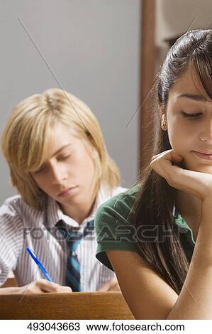 Two students studying in a classroom View Large Photo Image Stock Image - Two students studying in a classroom. Fotosearch