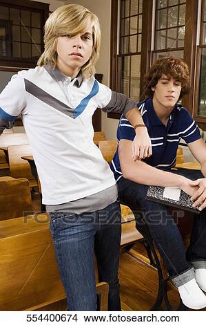 Picture - Two teenage boys in a classroom. Fotosearch