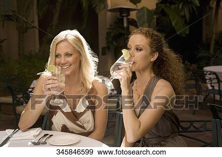 Two women drinking lemonade in a hotel, Biltmore Hotel, Coral Gables, Florida, USA View Large Photo Image Stock Photo - Two women drinking lemonade in a hotel, Biltmore Hotel, Coral Gables, Florida, USA. Fotosearch