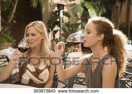 Stock Image - Two women enjoying drinks, Biltmore Hotel, Coral Gables, Florida, USA. Fotosearch