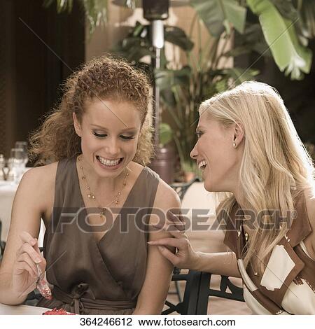 Stock Image - Two women having lunch and smiling, Biltmore Hotel, Coral Gables, Florida, USA. Fotosearch
