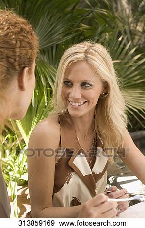 Stock Photo - Two women having lunch and smiling, Biltmore Hotel, Coral Gables, Florida, USA. Fotosearch