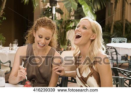 Stock Photo - Two women having lunch and smiling, Biltmore Hotel, Coral Gables, Florida, USA. Fotosearch