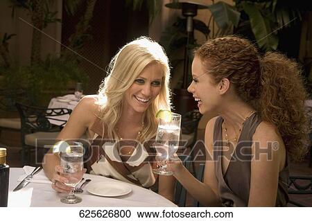 Two women smiling and holding drinks in a hotel, Biltmore Hotel, Coral Gables, Florida, USA View Large Photo Image Stock Image - Two women smiling and holding drinks in a hotel, Biltmore Hotel, Coral Gables, Florida, USA. Fotosearch