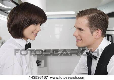 Waiter and waitress romancing in the kitchen View Large Photo Image Stock Photo - Waiter and waitress romancing in the kitchen. Fotosearch