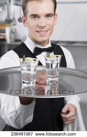 Waiter holding a tray of tequila shots View Large Photo Image Stock Photo - Waiter holding a tray of tequila shots. Fotosearch