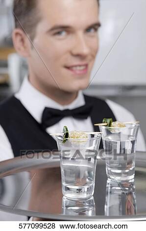 Waiter holding a tray of tequila shots View Large Photo Image Stock Photo - Waiter holding a tray of tequila shots. Fotosearch