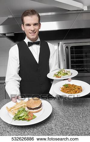 Waiter holding plates of foods View Large Photo Image Stock Photograph - Waiter holding plates of foods. Fotosearch