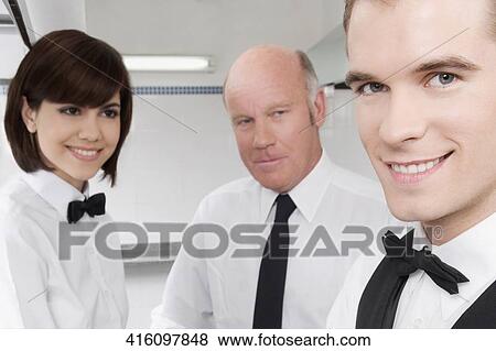 Waiters in a restaurant View Large Photo Image Stock Photo - Waiters in a restaurant. Fotosearch