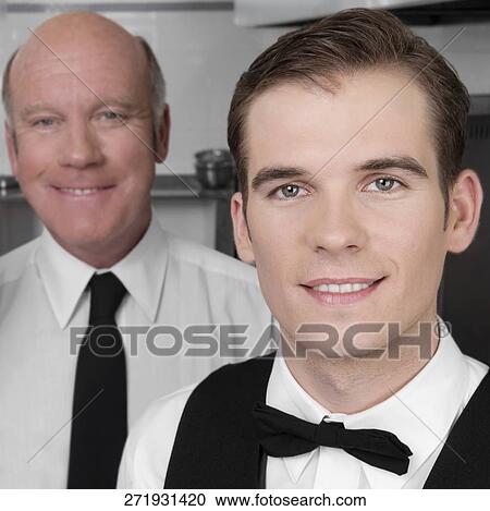 Waiters standing in the kitchen View Large Photo Image Stock Image - Waiters standing in the kitchen. Fotosearch