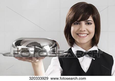 Waitress holding a domed tray View Large Photo Image Stock Photo - Waitress holding a domed tray. Fotosearch