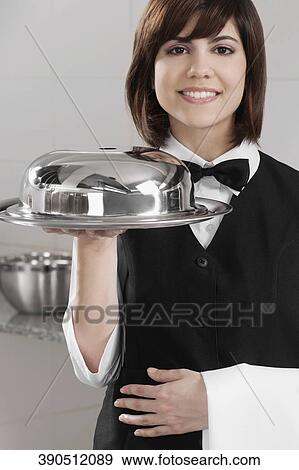 Waitress holding a domed tray View Large Photo Image Stock Photo - Waitress holding a domed tray. Fotosearch