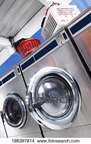 Washing machines in a laundromat View Large Photo Image Picture - Washing machines in a laundromat. Fotosearch