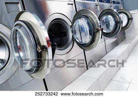 Washing machines in a laundromat View Large Photo Image Stock Image - Washing machines in a laundromat. Fotosearch
