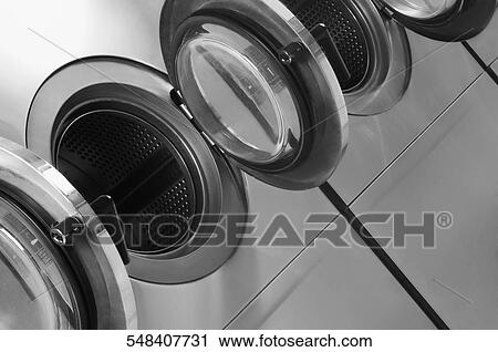 Stock Image - Washing machines in a laundromat. Fotosearch