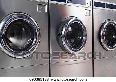 Stock Photo - Washing machines in a laundromat. Fotosearch