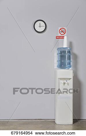 Water cooler near a wall View Large Photo Image Picture - Water cooler near a wall. Fotosearch