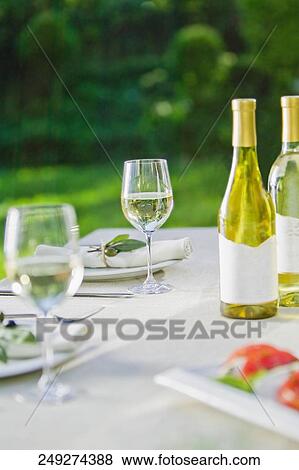 Wine glasses with a wine bottle on a table View Large Photo Image Stock Photo - Wine glasses with a wine bottle on a table. Fotosearch