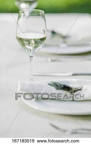 Stock Photo - Wine glasses with plates on a table. Fotosearch