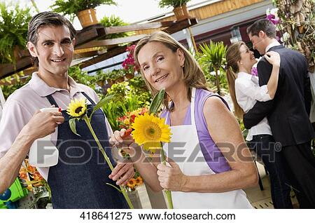 Woman and a man working in a greenhouse View Large Photo Image Stock Photography - Woman and a man working in a greenhouse. Fotosearch