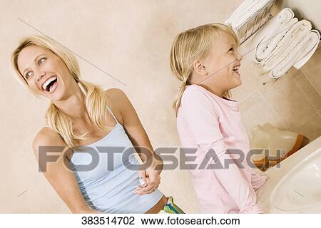Woman and her daughter laughing in the bathroom View Large Photo Image Stock Image - Woman and her daughter laughing in the bathroom. Fotosearch