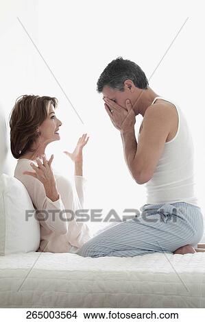 Picture - Woman arguing with a man in the bedroom. Fotosearch