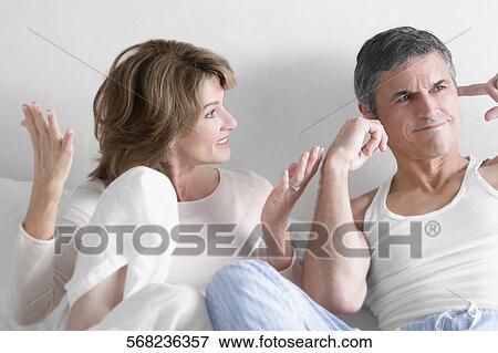 Stock Photo - Woman arguing with a man in the bedroom. Fotosearch