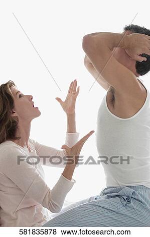 Stock Photo - Woman arguing with a man in the bedroom. Fotosearch