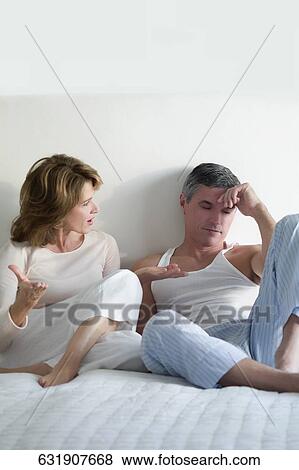 Woman arguing with a man in the bedroom View Large Photo Image Stock Photo - Woman arguing with a man in the bedroom. Fotosearch