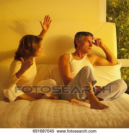 Stock Photography - Woman arguing with a man in the bedroom. Fotosearch