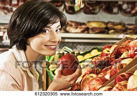 Woman buying apples in a supermarket View Large Photo Image Stock Photography - Woman buying apples in a supermarket. Fotosearch