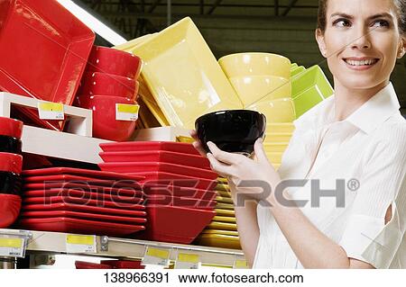 Woman buying crockery in a supermarket View Large Photo Image Stock Image - Woman buying crockery in a supermarket. Fotosearch