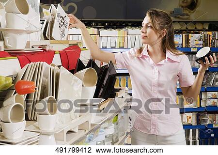 Woman buying crockery in a supermarket View Large Photo Image Stock Image - Woman buying crockery in a supermarket. Fotosearch