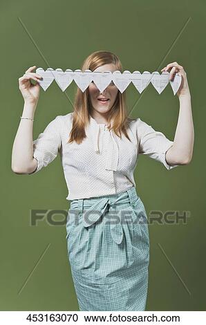 Woman covering her eyes with a heart shaped paper chain View Large Photo Image Stock Image - Woman covering her eyes with a heart shaped paper chain. Fotosearch
